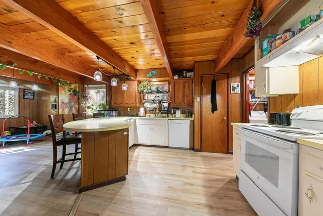 a kitchen with stainless steel appliances granite countertop a stove a sink dishwasher and a refrigerator