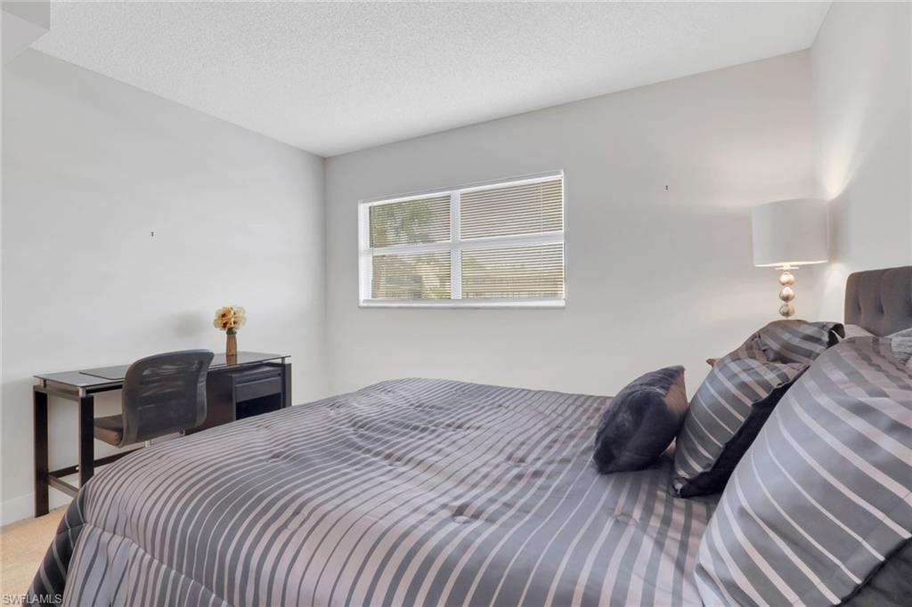 5499 Rattlesnake Hamm Road, Unit 2 Naples, FL 34113 - Photo 13 of 34 a bedroom with a bed and a closet