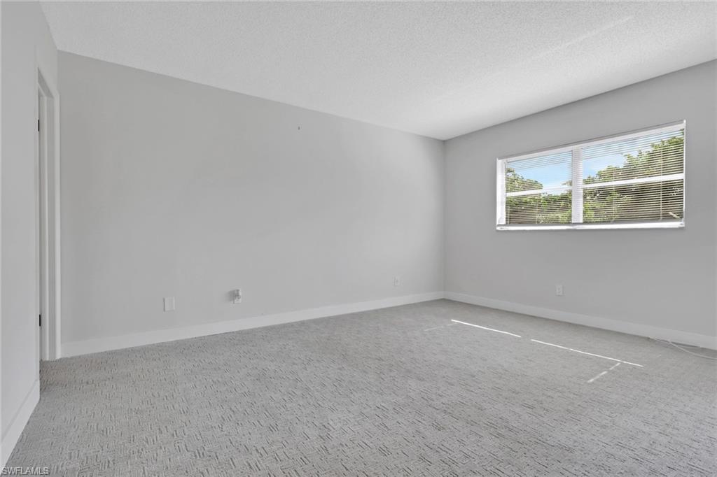 5499 Rattlesnake Hamm Road, Unit 2 Naples, FL 34113 - Photo 15 of 34 an empty room with windows