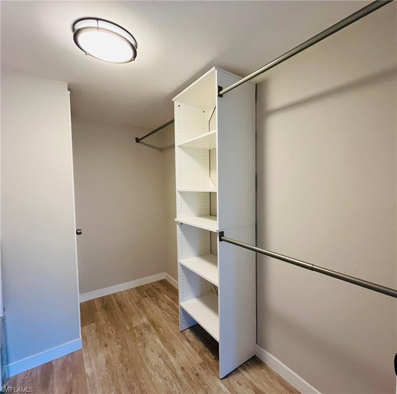 5499 Rattlesnake Hamm Road, Unit 2 Naples, FL 34113 - Photo 15 of 23 Huge walk-in closet featuring light wood-style floors