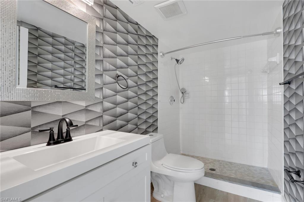 5499 Rattlesnake Hamm Road, Unit 2 Naples, FL 34113 - Photo 18 of 34 a bathroom with a sink toilet and shower