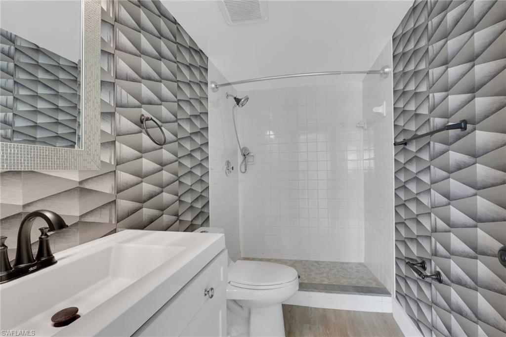 5499 Rattlesnake Hamm Road, Unit 2 Naples, FL 34113 - Photo 19 of 34 a bathroom with a sink toilet and shower