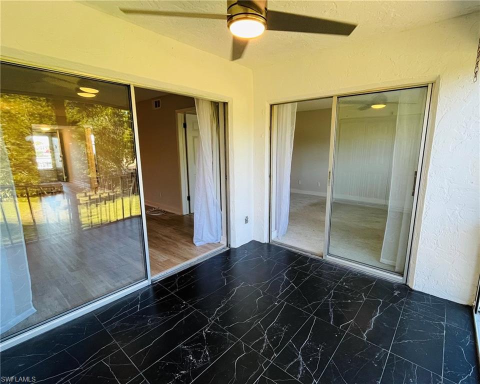 5499 Rattlesnake Hamm Road, Unit 2 Naples, FL 34113 - Photo 19 of 23 Lanai with sliding doors to main living area and primary bedroom