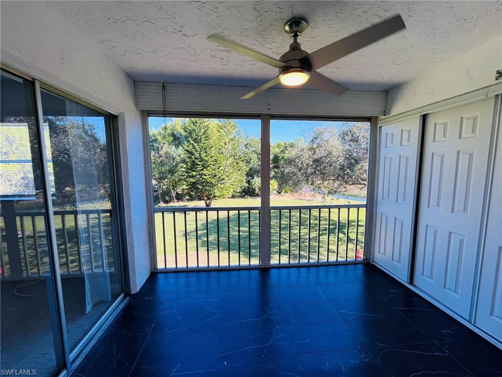 5499 Rattlesnake Hamm Road, Unit 2 Naples, FL 34113 - Photo 20 of 23 Large lanai with custom floor and newer fan