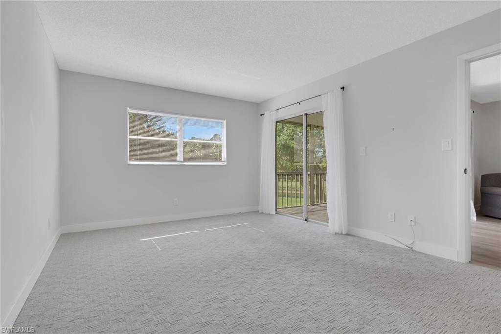5499 Rattlesnake Hamm Road, Unit 2 Naples, FL 34113 - Photo 20 of 34 an empty room with windows