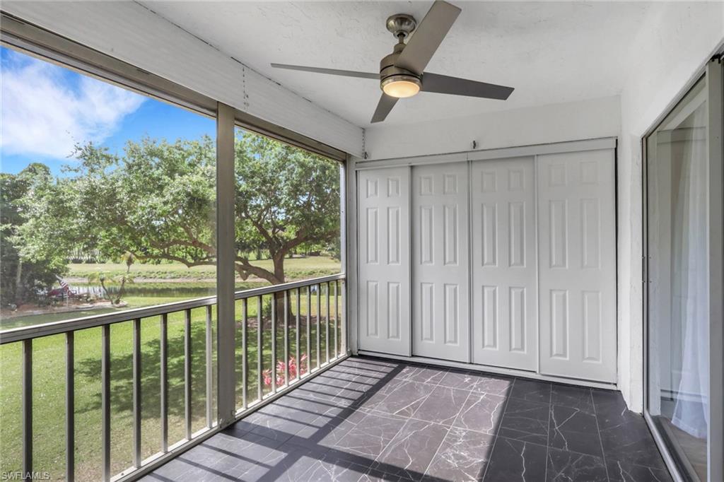 5499 Rattlesnake Hamm Road, Unit 2 Naples, FL 34113 - Photo 23 of 34 a view of a room with wooden floor fan and windows