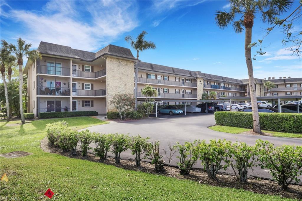 5499 Rattlesnake Hamm Road, Unit 2 Naples, FL 34113 - Photo 29 of 34 a view of a building with a garden