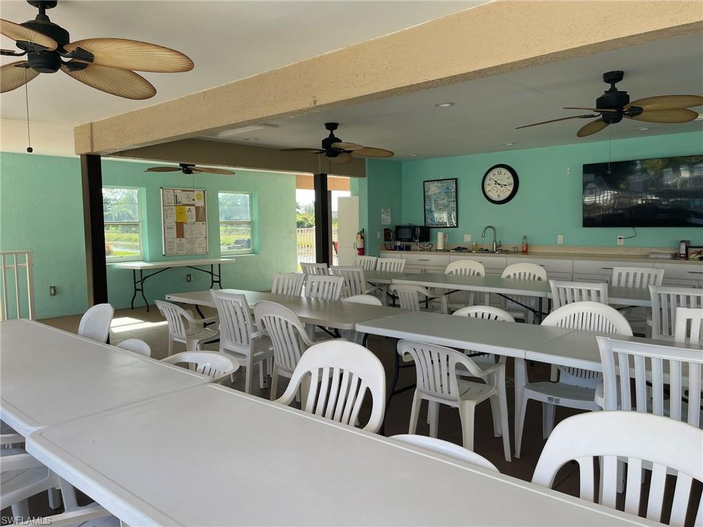 5499 Rattlesnake Hamm Road, Unit 2 Naples, FL 34113 - Photo 34 of 34 a living room with furniture and a flat screen tv