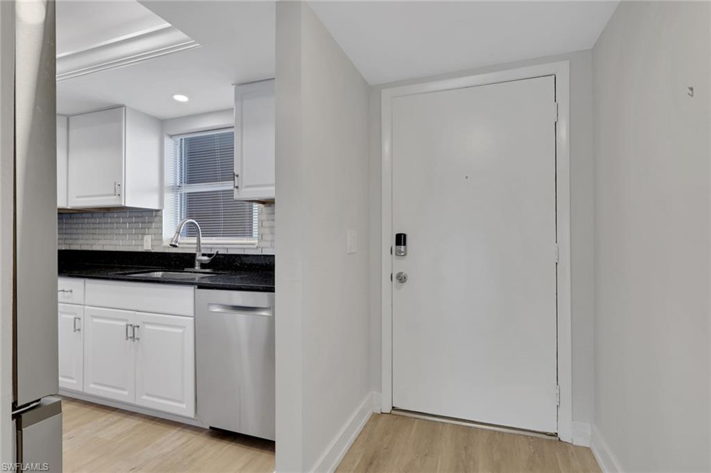 5499 Rattlesnake Hamm Road, Unit 2 Naples, FL 34113 - Photo 4 of 34 a kitchen with white cabinets