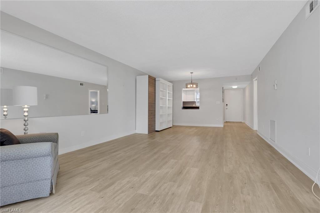 5499 Rattlesnake Hamm Road, Unit 2 Naples, FL 34113 - Photo 9 of 34 a view of empty room with wooden floor