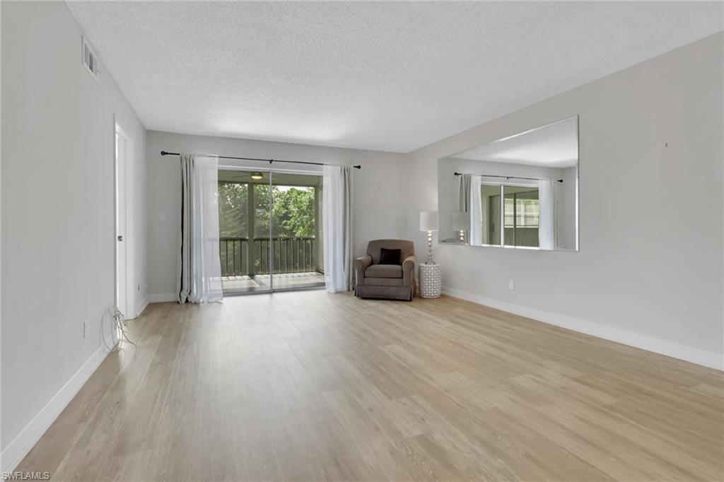 5499 Rattlesnake Hamm Road, Unit 2 Naples, FL 34113 - Photo 10 of 34 a view of a livingroom with furniture and staircase