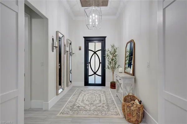 a view of front door with chandelier