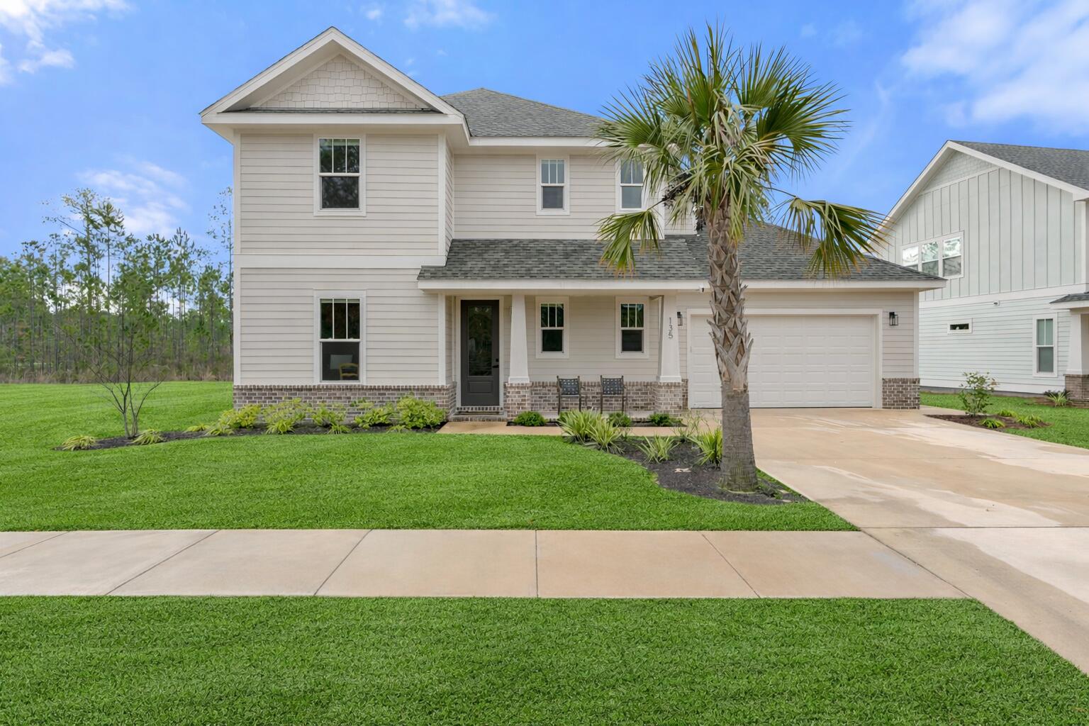 a front view of a house with a garden and plants