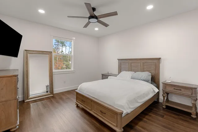 a bedroom with a bed and a flat screen tv