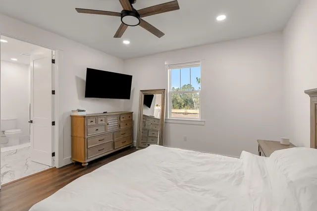 a bedroom with a bed and a flat screen tv