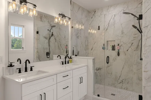a bathroom with a shower sink and mirror