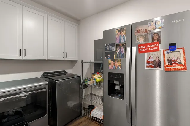 a view of water heater room with refrigerator and toys