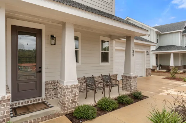 a view of a patio with table and chairs and potted plants