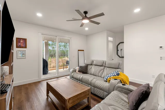 a living room with furniture and wooden floor