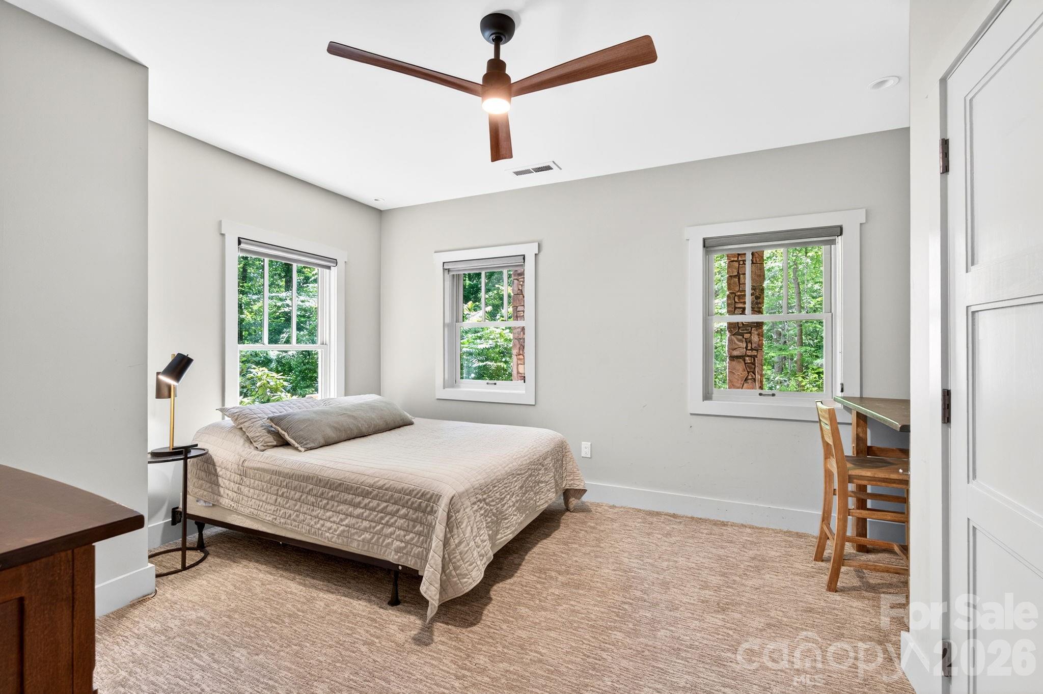 235 Bull Creek Road Asheville, NC 28805 - Photo 40 of 47 a bedroom with a bed a window and a couch