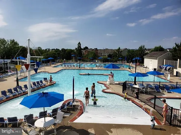 a view of a swimming pool with outdoor seating