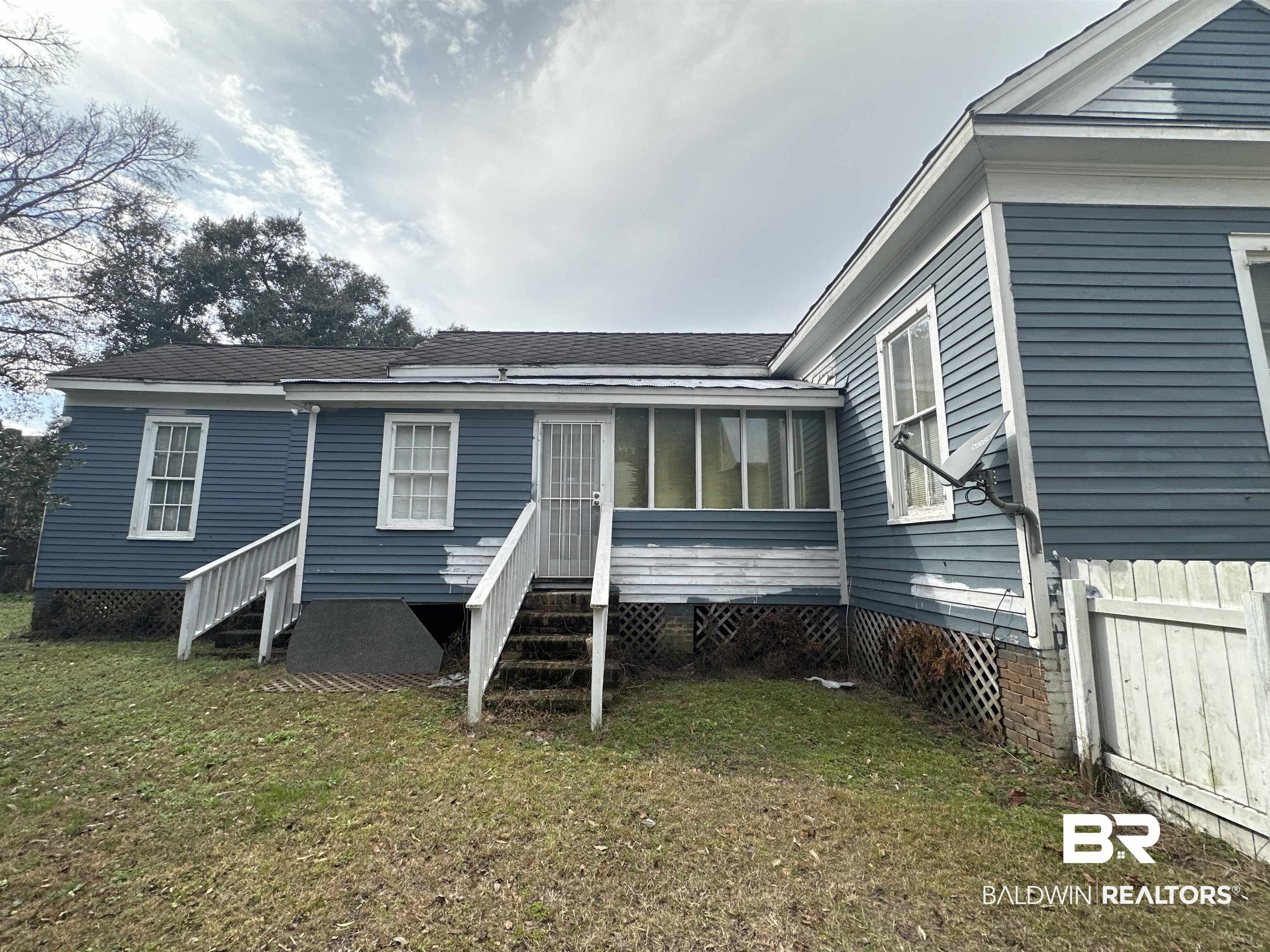 1119 Old Shell Road Mobile, AL 36604 - Photo 21 of 22 Rear view of house featuring a yard and a sunroom