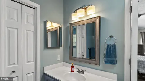 a bathroom with a sink mirror and vanity