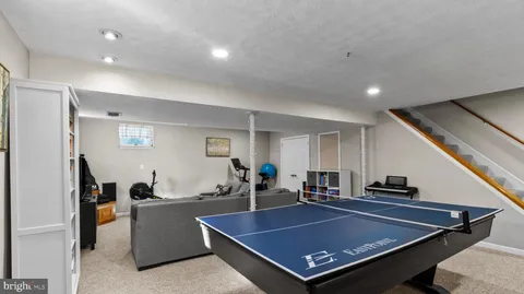 a living room with furniture pool and table