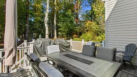 a view of balcony with wooden floor and outdoor seating
