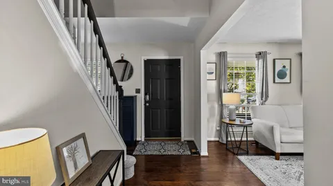a view of an entryway with wooden floor and a livingroom