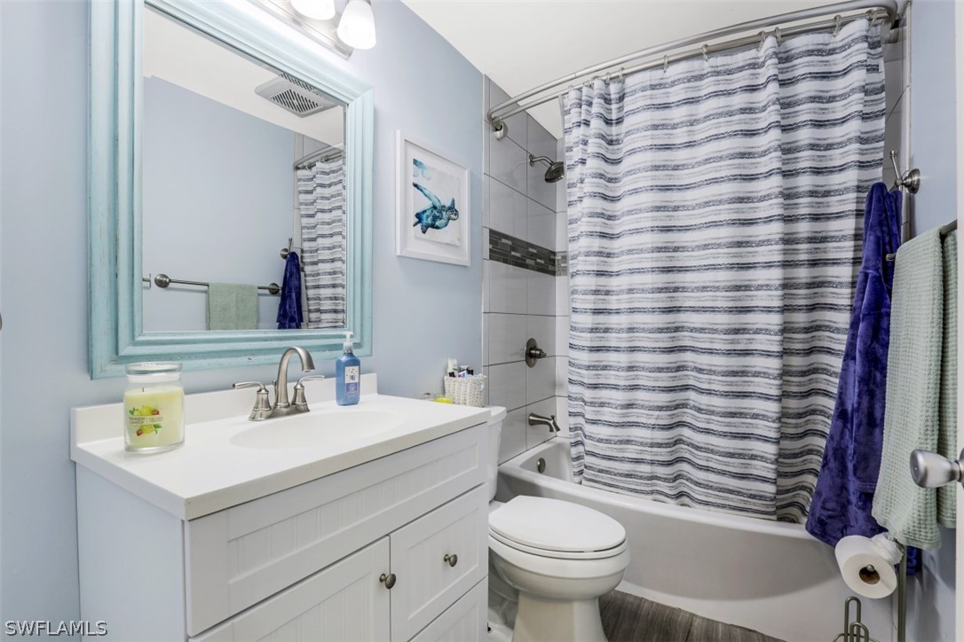 701 East 14th Street Lehigh Acres, FL 33972 - Photo 13 of 31 a bathroom with a sink a toilet and shower curtain