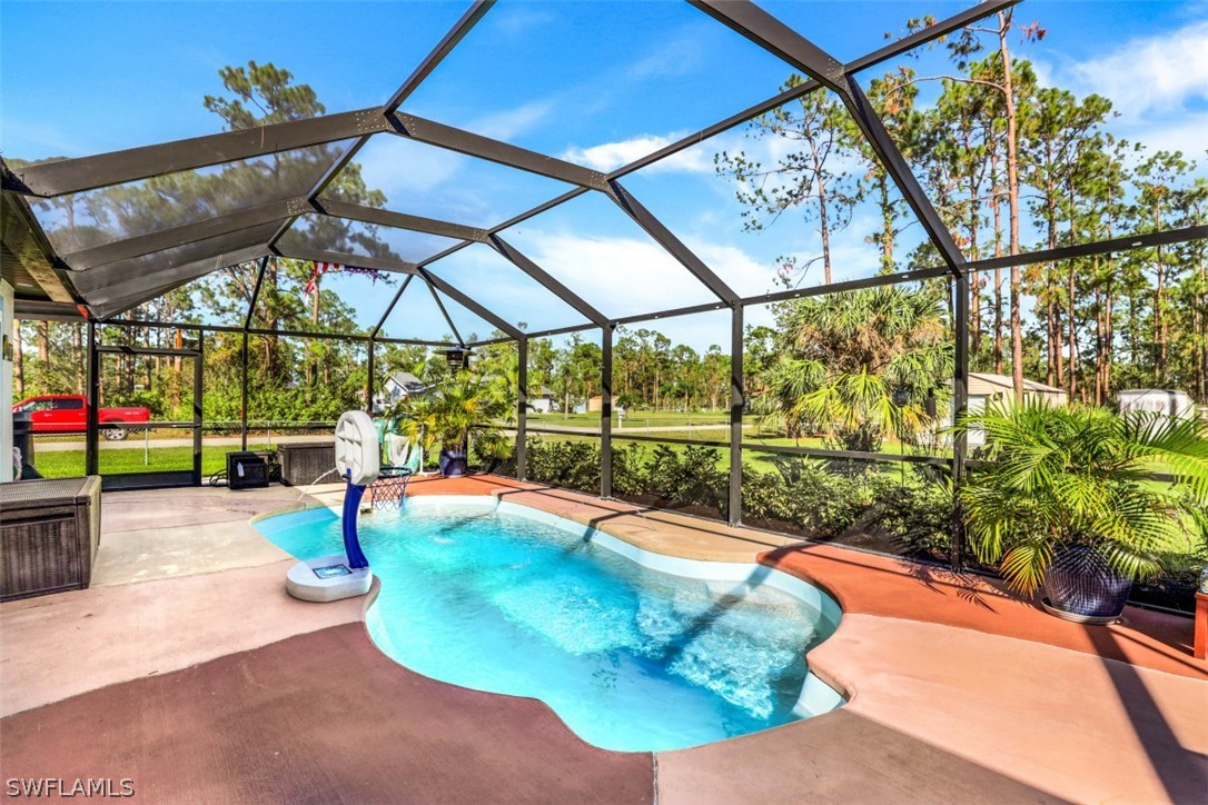 701 East 14th Street Lehigh Acres, FL 33972 - Photo 19 of 31 a view of a swimming pool with a patio