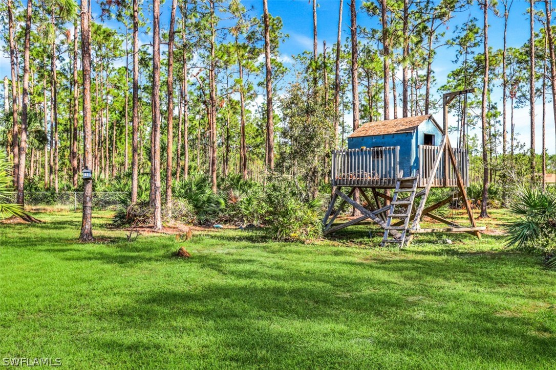 701 East 14th Street Lehigh Acres, FL 33972 - Photo 25 of 31 a view of outdoor space with deck and bench