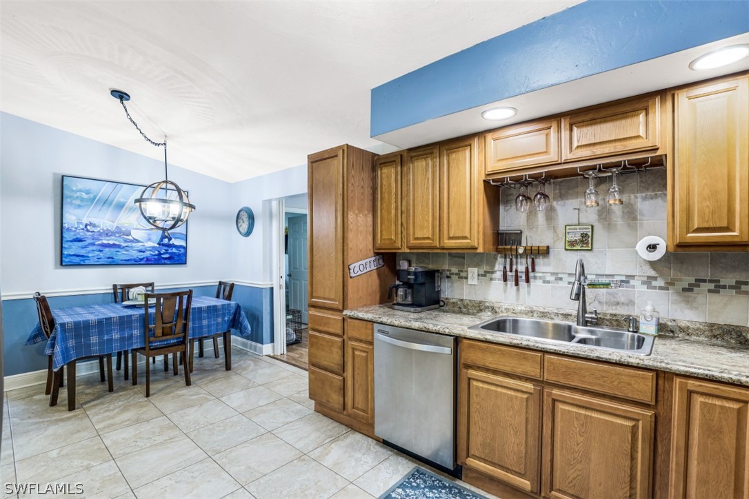 701 East 14th Street Lehigh Acres, FL 33972 - Photo 7 of 31 a kitchen with stainless steel appliances granite countertop a sink and cabinets