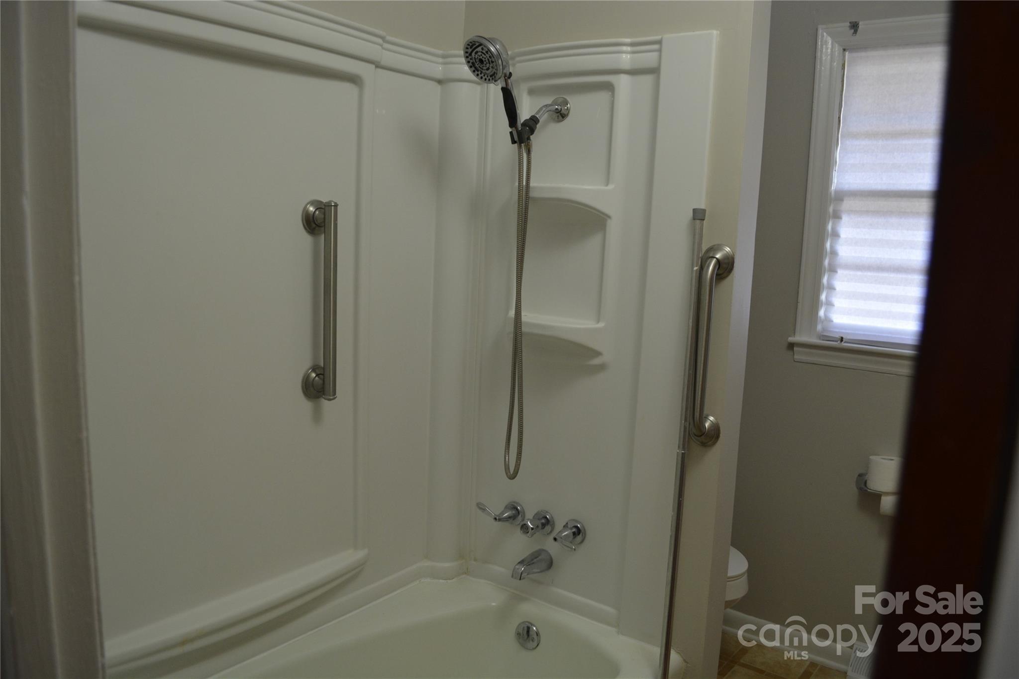 1206 Borders Road Shelby, NC 28150 - Photo 13 of 25 a bathroom with a bathtub and a shower