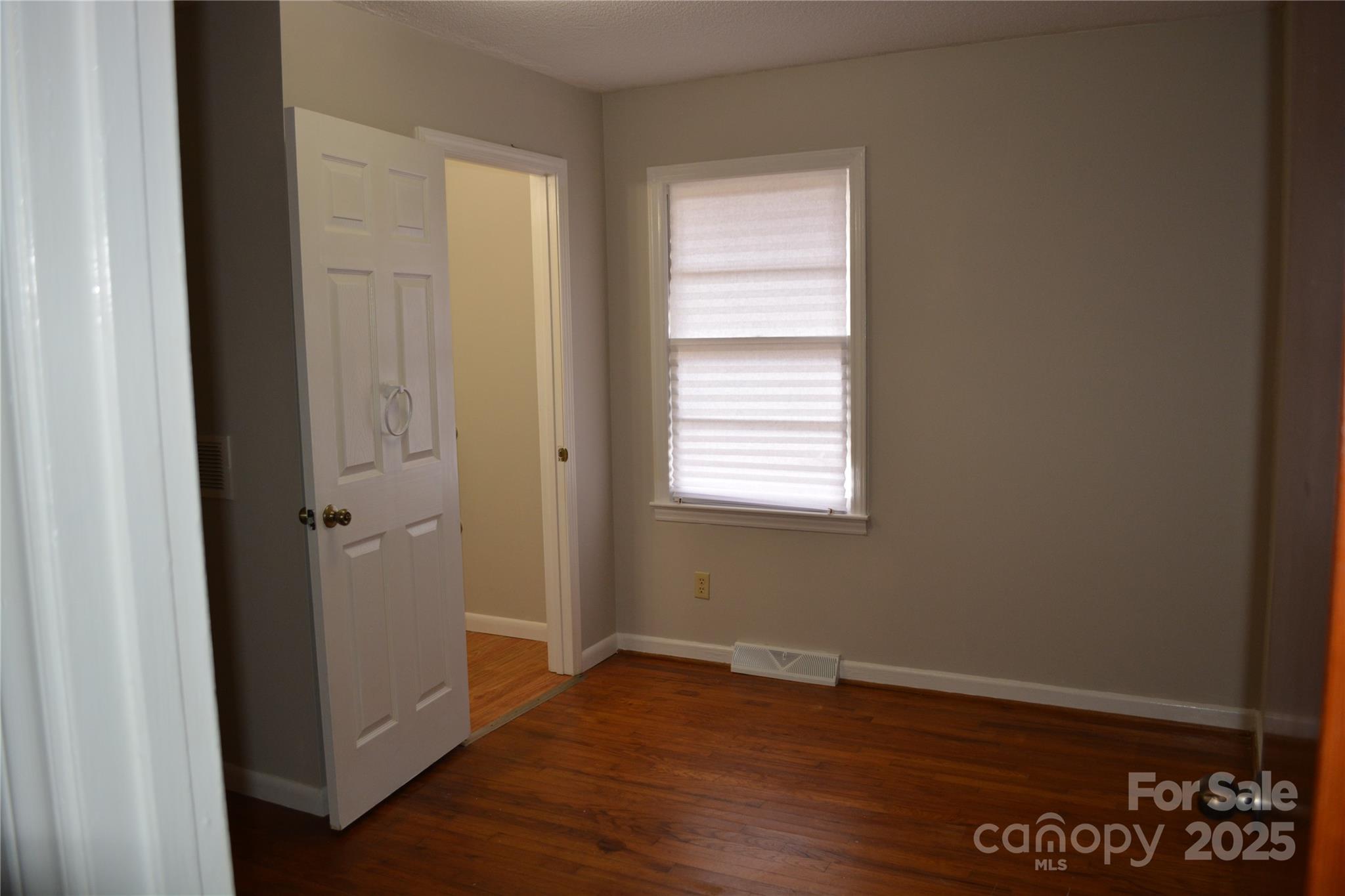 1206 Borders Road Shelby, NC 28150 - Photo 16 of 25 a view of an empty room with wooden floor and a window