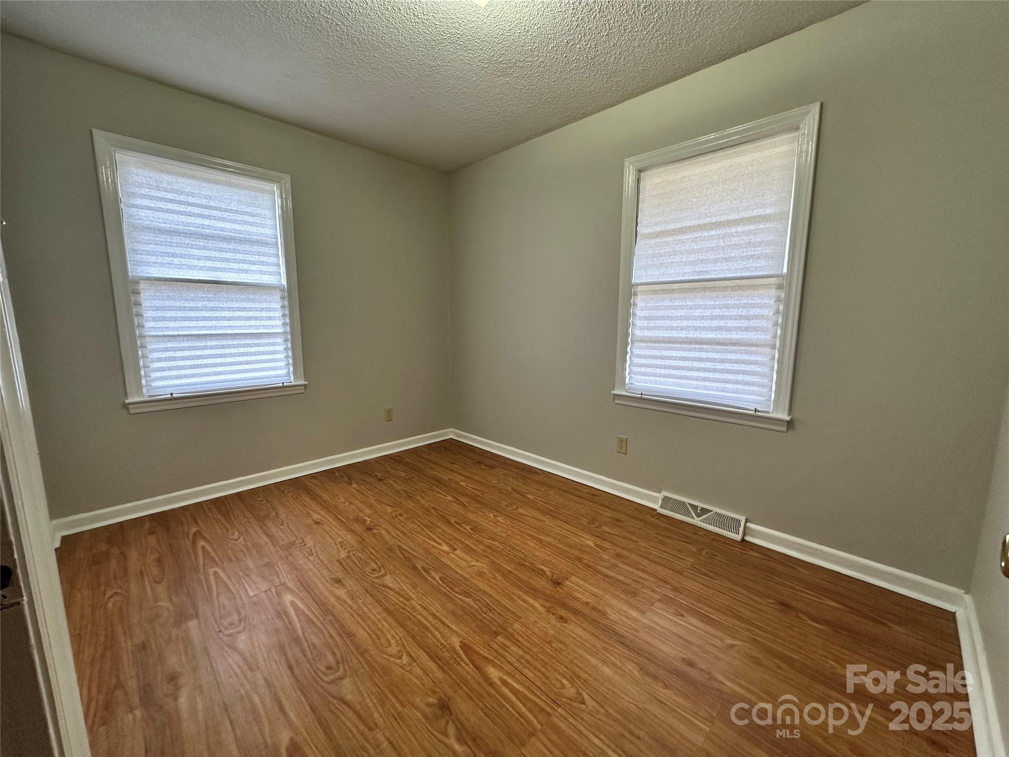 1206 Borders Road Shelby, NC 28150 - Photo 17 of 25 a view of an empty room with wooden floor and a window