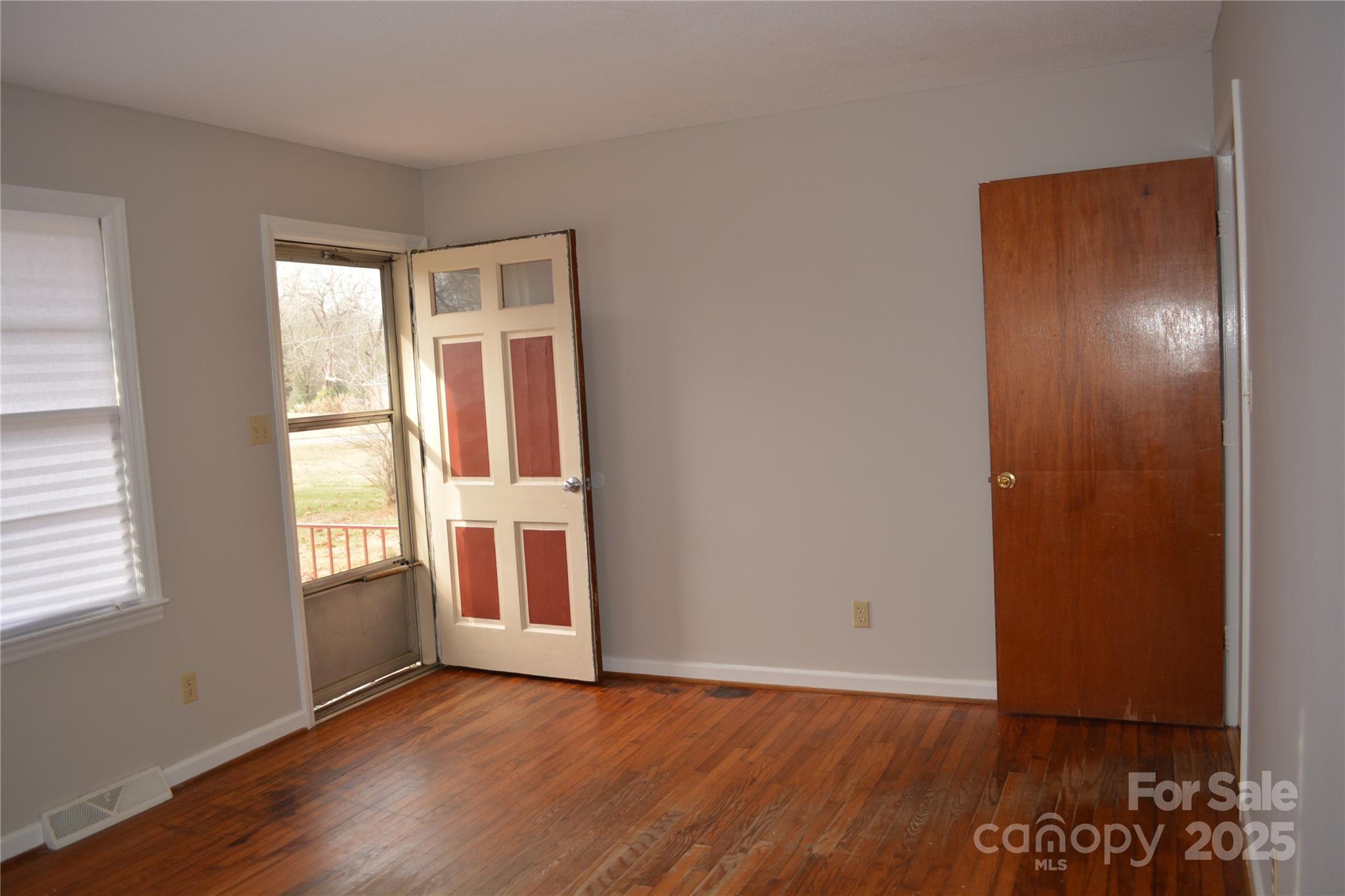 1206 Borders Road Shelby, NC 28150 - Photo 4 of 25 an empty room with wooden floor and windows