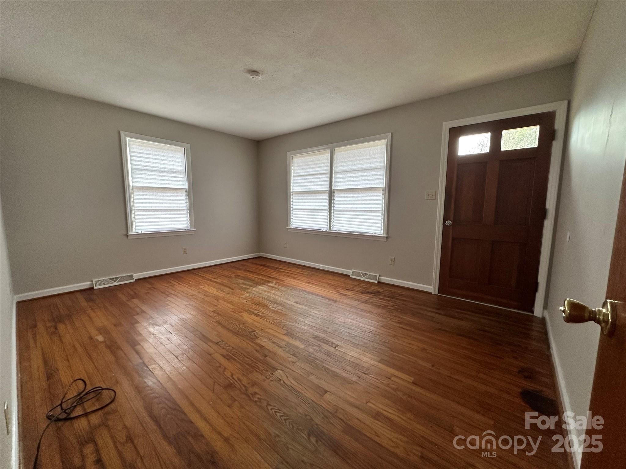 1206 Borders Road Shelby, NC 28150 - Photo 6 of 25 an empty room with wooden floor and windows