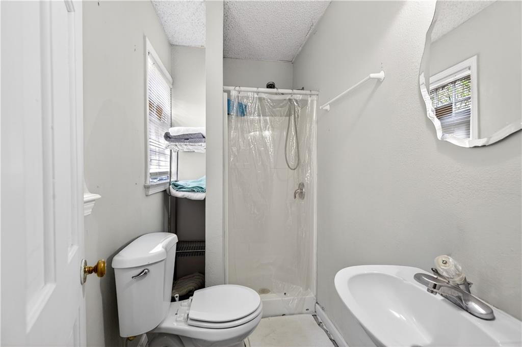 1742 Cardinal Road Hampton, GA 30228 - Photo 14 of 25 a bathroom with a sink toilet and shower