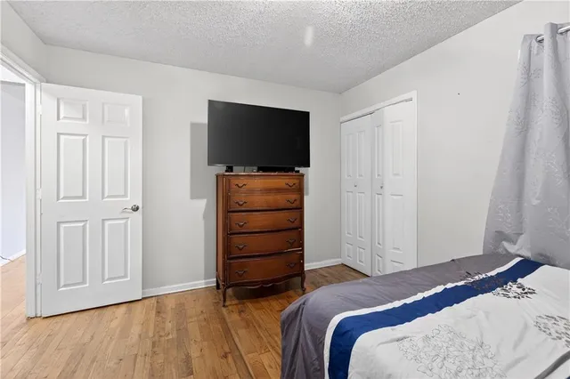 a bedroom with a bed and a television