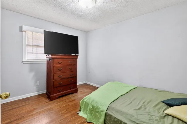 a bedroom with a bed and flat screen tv