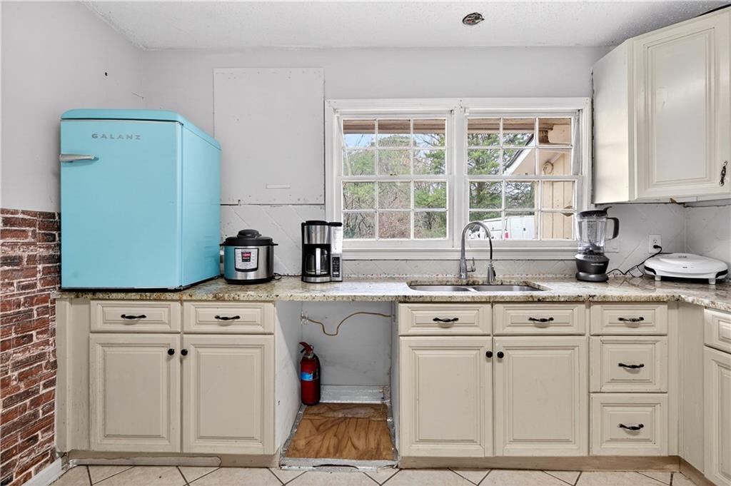 1742 Cardinal Road Hampton, GA 30228 - Photo 6 of 25 a kitchen with white cabinets and sink