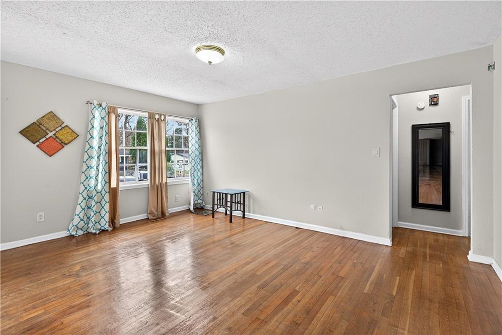 1742 Cardinal Road Hampton, GA 30228 - Photo 10 of 25 an empty room with wooden floor and a window
