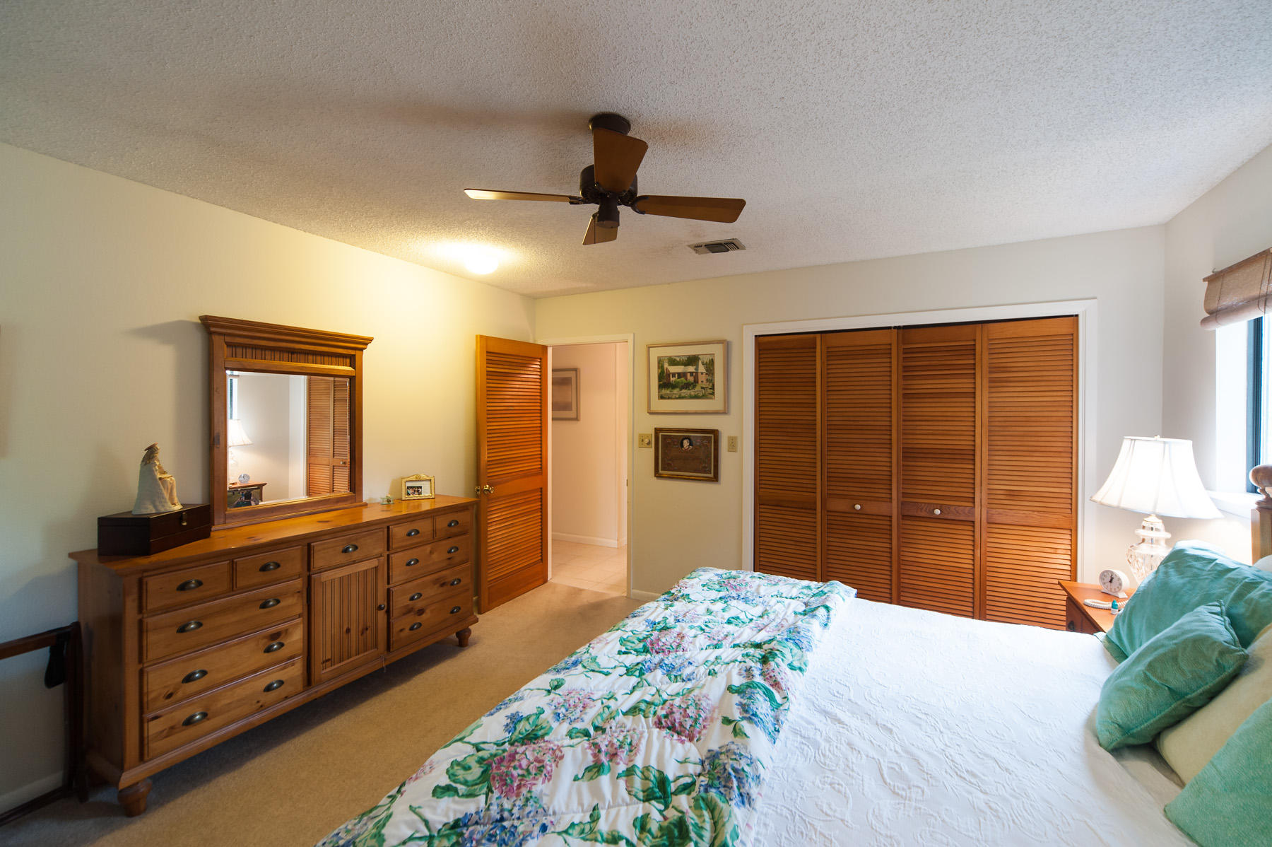 568 Ridge Road Santa Rosa Beach, FL 32459 - Photo 17 of 31 a bedroom with a bed dresser and a large mirror