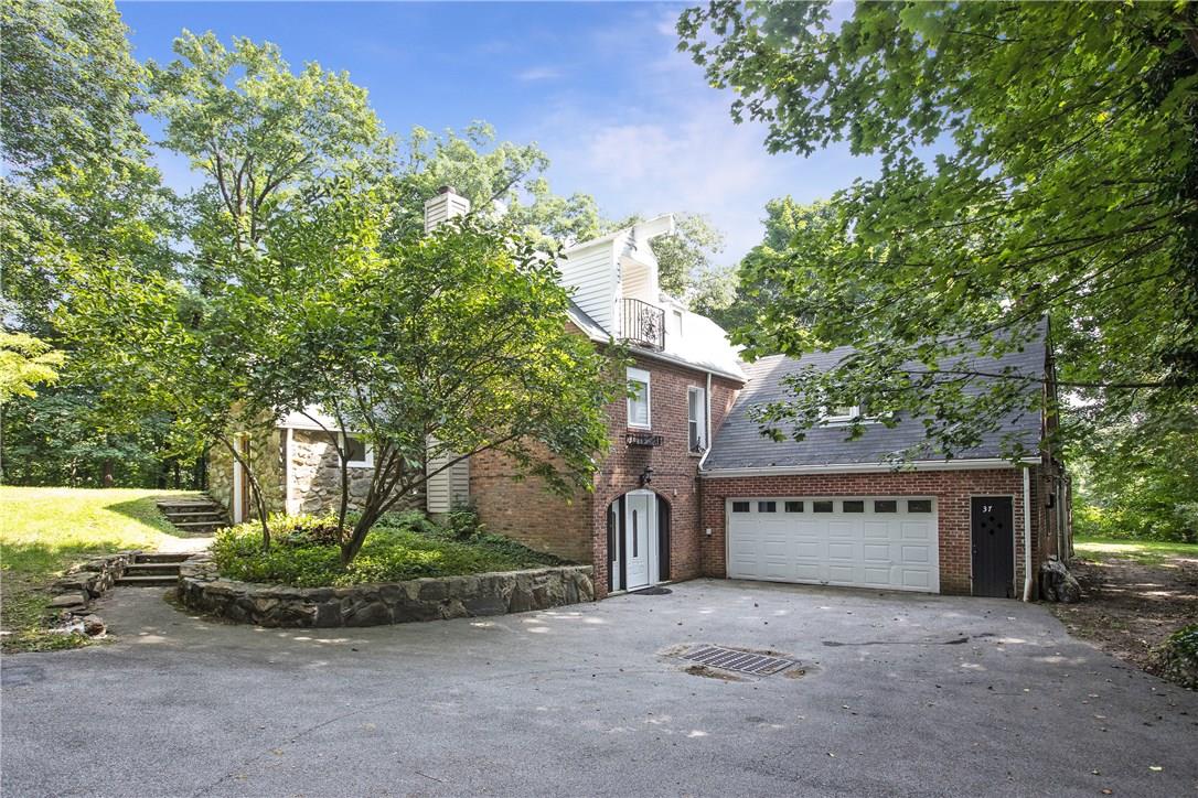 37 Greenmeadow Road Pleasantville, NY 10570 - Photo 1 of 1 a front view of a house with a yard and garage