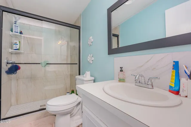 a kitchen view with stainless steel appliances wooden floor and chair