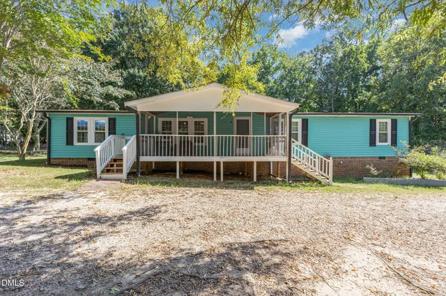a view of a patio with wooden floor and iron stairs