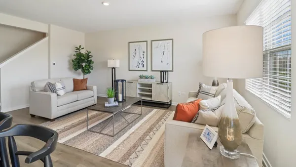 a living room with furniture and a lamp