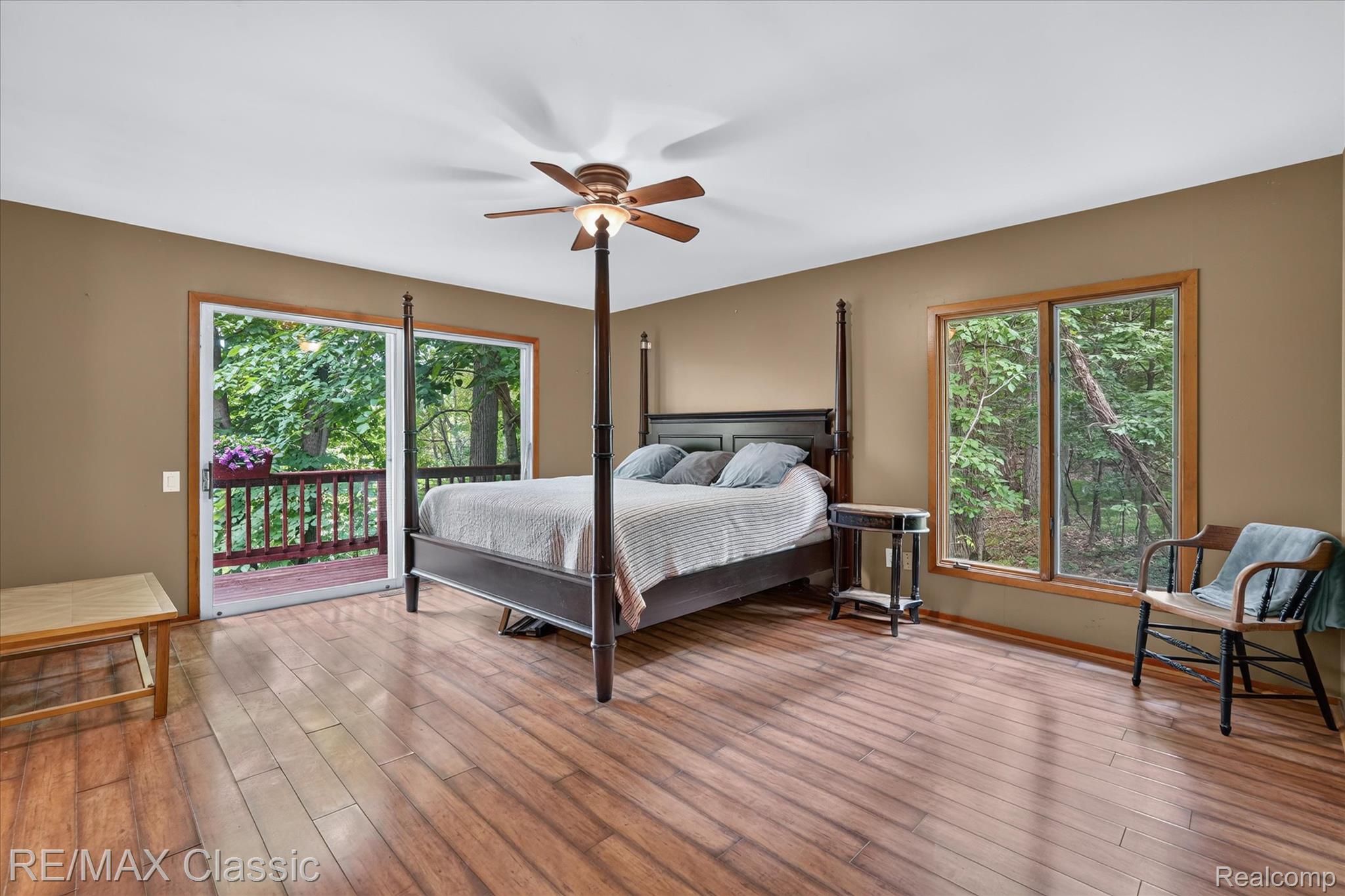 12189 Gage Road Holly, MI 48442 - Photo 18 of 69 Spacious room featuring wood-finish flooring, a ceiling fan, and two large windows with natural wood trim